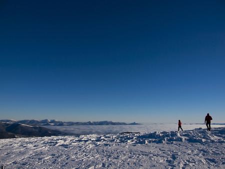 Men on the background of snow-capped mountains and blue sky.の写真素材