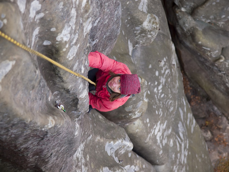 A young climber climbs on the vertical wall.の写真素材
