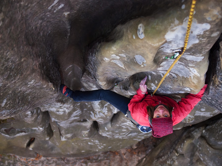 A young climber climbs on the vertical wall.の写真素材