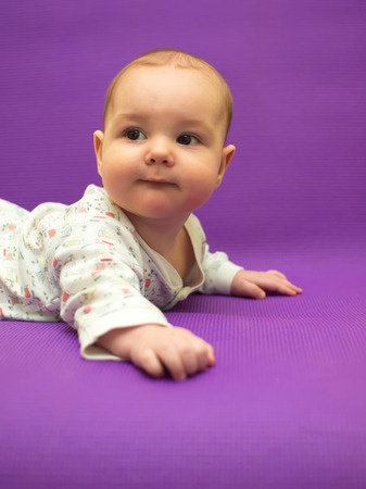 Infant on a purple background. Baby on a purple background.の写真素材