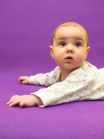Infant on a purple background. Baby on a purple background.の写真素材