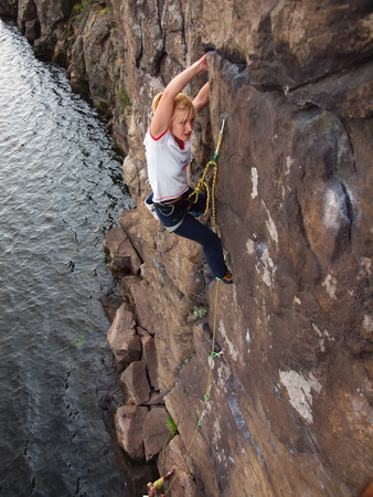 A young climber climbs on the vertical wall.の写真素材