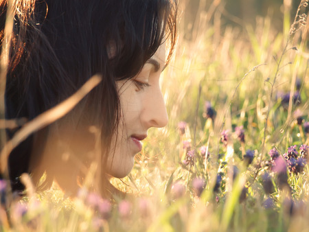 Girl lying in a field of flowers and smiling.の写真素材