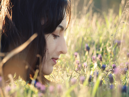 Girl lying in a field of flowers.の写真素材