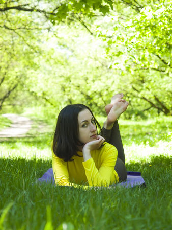 Girl lying in a clearing in the forest.の写真素材