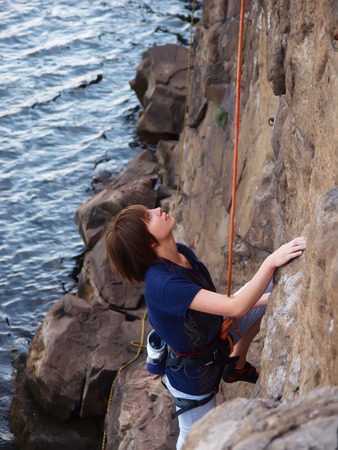 A young climber climbs on the vertical wall.の写真素材