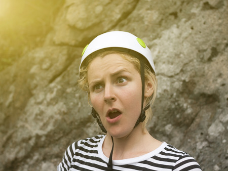 Surprised face of a young girl a climber in helmets for safety.の写真素材