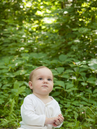 An infant learning to crawl in the Park in the fresh air.の写真素材