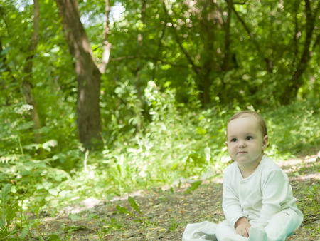 An infant learning to crawl in the Park in the fresh air.の写真素材