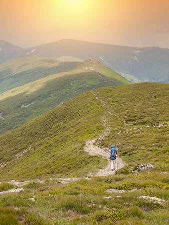 People walk along the ridge with backpacks.の写真素材