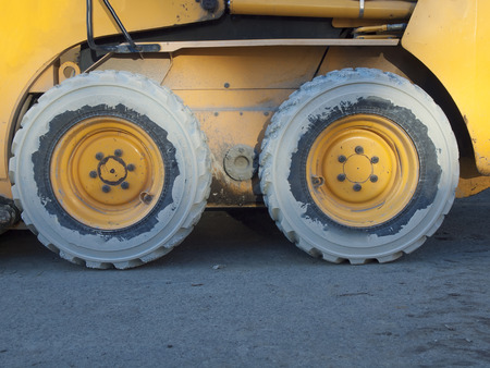 Big wheels construction vehicles are on site.の写真素材