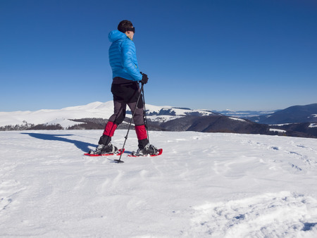 Male climbers in snowshoes and goes on soft snow in the mountains.の写真素材