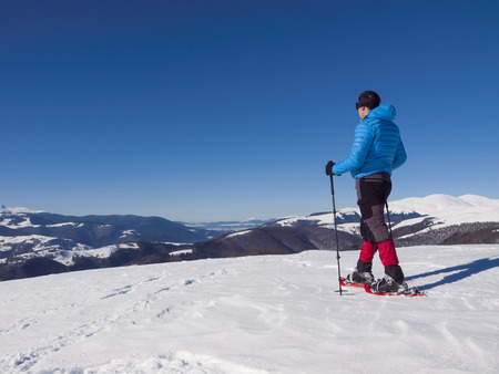 Male climbers in snowshoes and goes on soft snow in the mountains.の写真素材