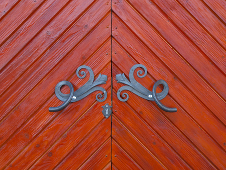 Old wooden door with metal fittings handmade.の写真素材