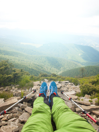 The feet of the man who walked through the mountains and sat down to rest.の写真素材