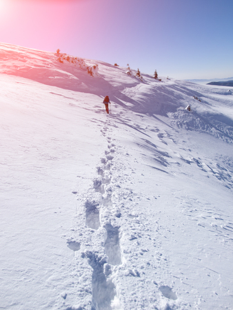 The climber in the mountains is complicated by a winter trail.の写真素材