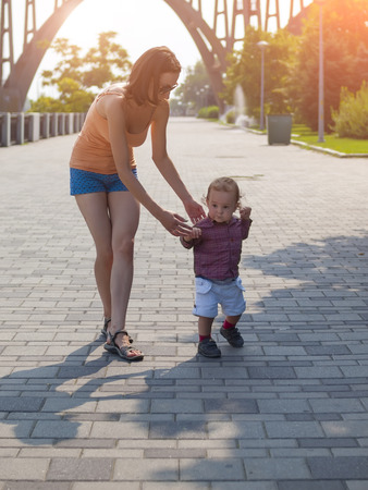 A small child played with a young mother in nature.の写真素材