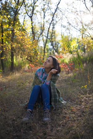 Girl modit on the grass in the forest.の写真素材
