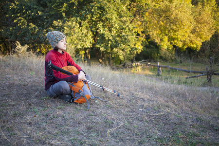 The girl with the backpack rest on the nature.の写真素材