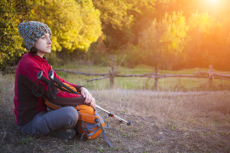 The girl with the backpack rest on the nature.の写真素材
