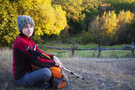 The girl with the backpack rest on the nature.の写真素材