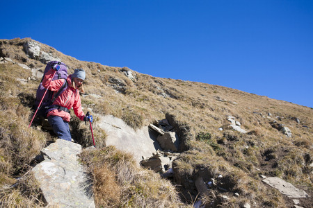 Tourist with backpack standing on a mountain.の写真素材