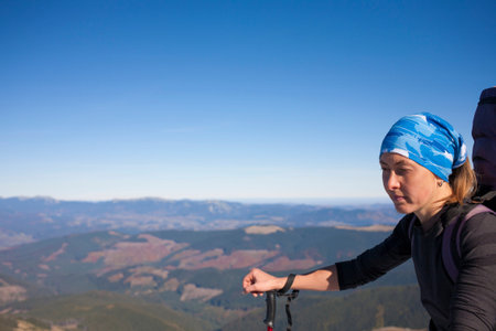 Portrait of a girl on top of a mountain.