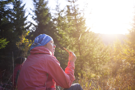 Young girl eating cookie in a forest glade.の写真素材