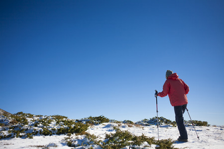 The girl walks in the mountains on snow.の写真素材