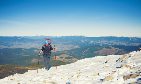 Girl with backpack is traveling in the mountains.の写真素材