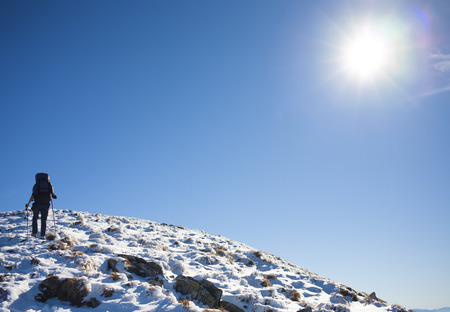 Girl with backpack is traveling in the mountains.の写真素材
