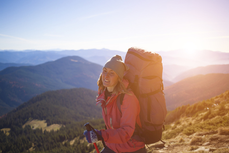 A girl stands on top of a mountain.の写真素材