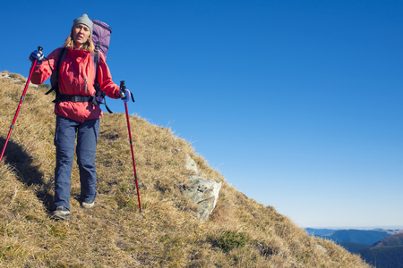The woman with the backpack is on a dangerous slope.の写真素材
