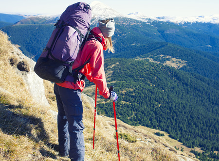The woman with the backpack is on a dangerous slope.の写真素材