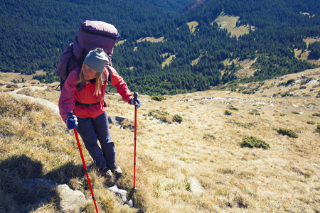 The woman with the backpack is on a dangerous slope.の写真素材