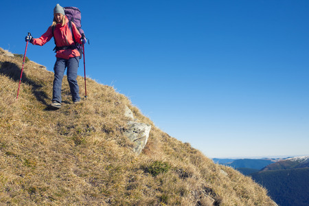 The woman with the backpack is on a dangerous slope.の写真素材
