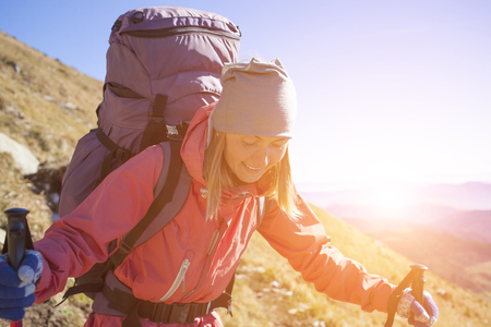 Tourist with a backpack goes on a mountain road.の写真素材