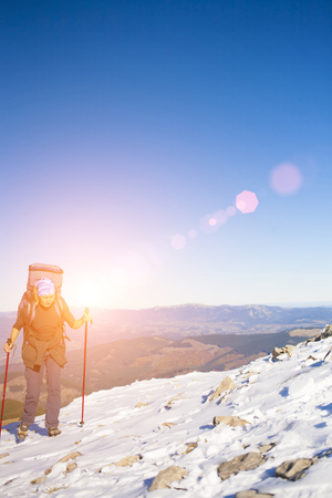 Climber with backpack is the snowy slope.の写真素材