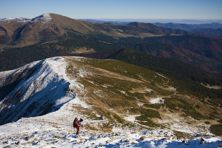 The girl with the backpack goes to the mountain top.の写真素材