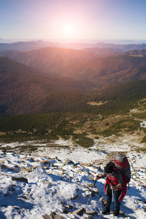 The girl with the backpack goes to the mountain top.の写真素材