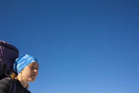 Portrait of girl climbers on the blue sky background.の写真素材