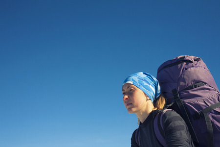 Portrait of girl climbers on the blue sky background.の写真素材