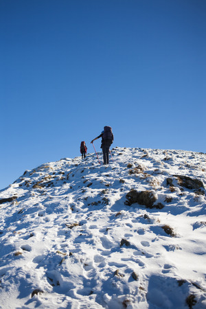 Two climbers are on a dangerous snow slope.の写真素材