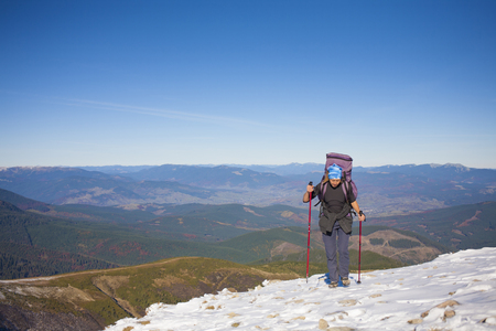 Climber with a backpack is on a slope.の写真素材