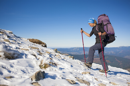 Tourist with a backpack is the snowy slope.の写真素材