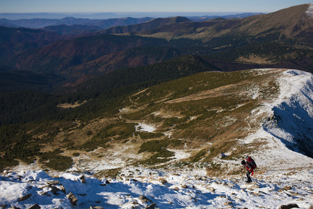 The girl with the backpack goes to the mountain top.の写真素材
