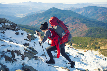 The climber climbs on dangerous snow slope.の写真素材