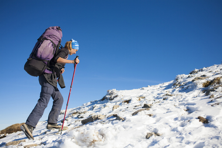 Tourist with a backpack is the snowy slope.の写真素材