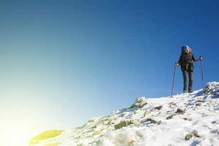 Climber with backpack is the snowy slope to his goal.の写真素材
