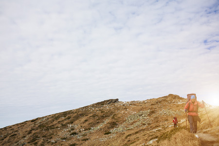 The girls go on a Hiking trail with backpacks.の写真素材